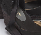 Geflochtene Fersenpartie und schwarze Bindebänder der Espadrilles